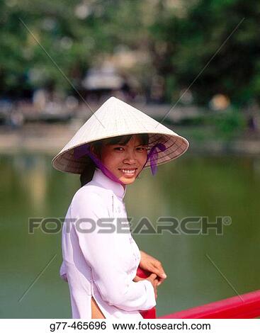Stock Photograph - Vietnamese woman in traditional dress, Ho Chi Minh City. Vietnam. Fotosearch