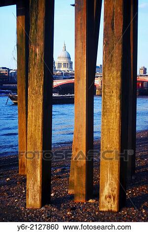 View across the River Thames to St. Paul's Cathedral at very low tide with the wooden pillars of an old pier in the foreground, in the heart of London, England. View Large Photo Image Stock Image - View across the River Thames to St. Paul's Cathedral at very low tide with the wooden pillars of an old pier in the foreground, in the heart of London, England.. Fotosearch