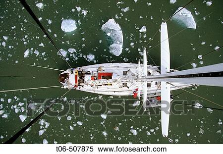 View down from top of mast to deck of sailing boat passing iceberg, King's Bay, Svalbard, Spitzbergen, Norway View Large Photo Image Stock Photography - View down from top of mast to deck of sailing boat passing iceberg, King's Bay, Svalbard, Spitzbergen, Norway. Fotosearch