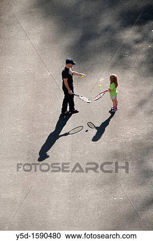 view from above, father showing his little daughter how to play tennis, Geneva, Switzerland View Large Photo Image Stock Image - view from above, father showing his little daughter how to play tennis, Geneva, Switzerland. Fotosearch