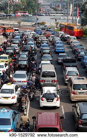 Stock Image - View from above with traffic jam on Jalan Sudirman at the intersection with BI Plaza Indonesia and a bus on a separated buslane, Jakarta, Java, Indonesia, Southeast Asia. Fotosearch