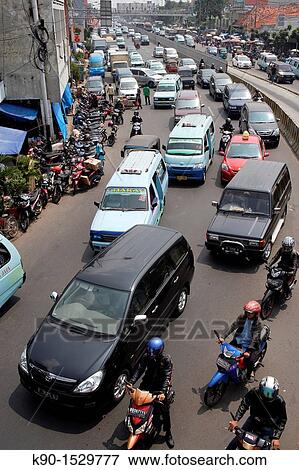 Stock Photo - View from above with traffic jam on Jalan Matraman with mini busses, Jakarta, Java, Indonesia, Southeast Asia. Fotosearch