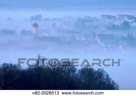 View from Hesselberg mountain on a small Bavarian village in fog - Region Hesselberg, Bavaria/Germany. View Large Photo Image Stock Image - View from Hesselberg mountain on a small Bavarian village in fog - Region Hesselberg, Bavaria/Germany.. Fotosearch