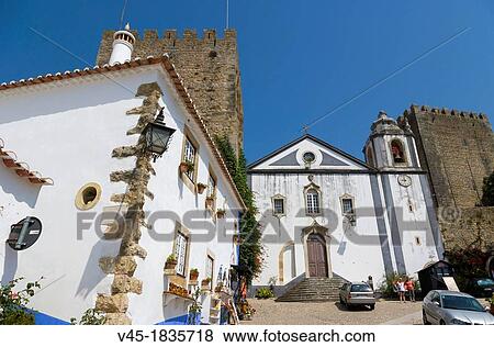 Stock Photo - View from Rua Direita with Igreja de Sao Tiago, Sai Tiago Church, Castelo de Obidos, Obidos Castle, Obidos, Leiria District, Pinhal Litoral, Portugal.. Fotosearch