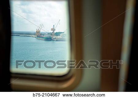 View from the cabin window of a ship of a dock with a cargo ship at the Port of Palma de Mallorca, Balearics, Spain. View Large Photo Image Stock Photo - View from the cabin window of a ship of a dock with a cargo ship at the Port of Palma de Mallorca, Balearics, Spain.. Fotosearch