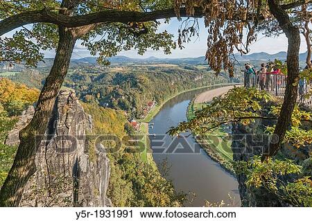 View from the spectacular rock formation Bastei (Bastion) to health resort Rathen and the Elbe River. View Large Photo Image Stock Image - View from the spectacular rock formation Bastei (Bastion) to health resort Rathen and the Elbe River.. Fotosearch