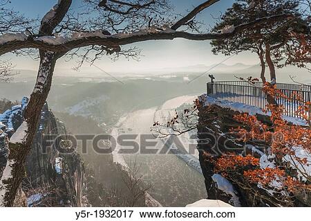 View from the spectacular rock formation Bastei (Bastion) to health resort Rathen and the Elbe River. View Large Photo Image Stock Photo - View from the spectacular rock formation Bastei (Bastion) to health resort Rathen and the Elbe River.. Fotosearch