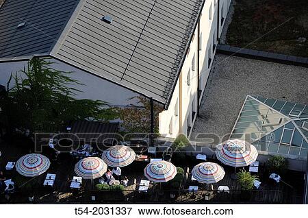 View from the tower of the old Peter a rooftop patio with umbrellas View Large Photo Image Stock Photo - View from the tower of the old Peter a rooftop patio with umbrellas. Fotosearch
