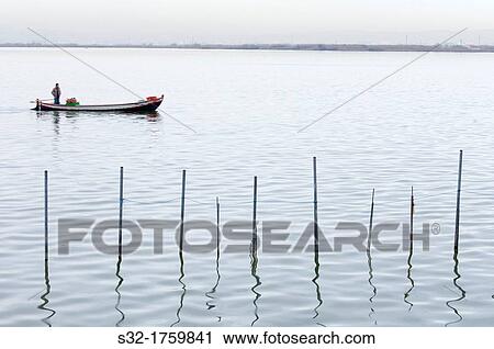 Stock Image - view of a boat in Albufera lake, Valencia, Spain. Fotosearch