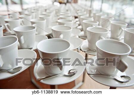 View of a display of empty white coffee cups View Large Photo Image Stock Photo - View of a display of empty white coffee cups. Fotosearch