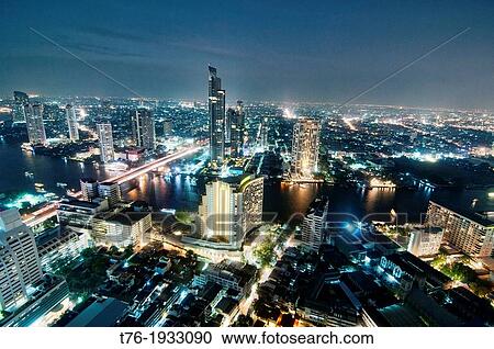 Stock Image - view of Bangkok and the Chao Phraya River by night, Thailand. Fotosearch