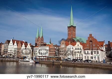 View of Lubeck, from the other side of one of the canals that surround the city, highlighting the tower of the Church of Santa Maria, and the tower of St Petry. Lubeck, Schleswig-Holstein, Germany. View Large Photo Image Stock Photo - View of Lubeck, from the other side of one of the canals that surround the city, highlighting the tower of the Church of Santa Maria, and the tower of St Petry. Lubeck, Schleswig-Holstein, Germany.. Fotosearch