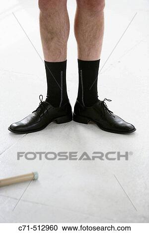 Stock Image - View of man's black shoes and socks.. Fotosearch