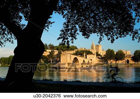 View of Pont d'Avignon (or Pont St Benezet) and Rhone river towards the Papes Palace in the early evening, Avignon city, in Provenza-Alpes-Cotes d'Azur region, France. View Large Photo Image Stock Photograph - View of Pont d'Avignon (or Pont St Benezet) and Rhone river towards the Papes Palace in the early evening, Avignon city, in Provenza-Alpes-Cotes d'Azur region, France.. Fotosearch