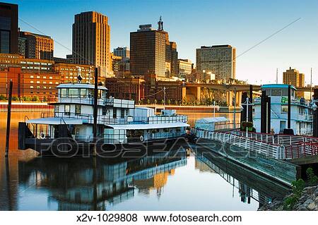 View of St Paul, Minnesota skyline and the former tugboat, now the Covington Inn Bed and Breakfast at dawn from the shore of Mississippi River View Large Photo Image Stock Photo - View of St Paul, Minnesota skyline and the former tugboat, now the Covington Inn Bed and Breakfast at dawn from the shore of Mississippi River. Fotosearch