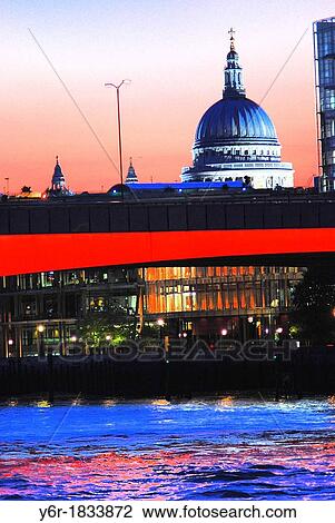 View of St Paul's Cathedral, the illuminated London Bridge and the River Thames at dusk in London, England on a Winter evening City of London offices glimmer in the dusk View Large Photo Image Stock Image - View of St Paul's Cathedral, the illuminated London Bridge and the River Thames at dusk in London, England on a Winter evening City of London offices glimmer in the dusk. Fotosearch