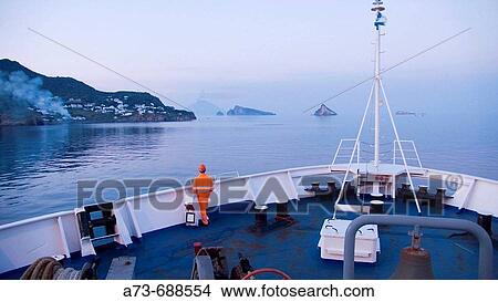 View of Stromboli and Basiluzzo from ferry boat. Eolian Islands, Sicily, Italy View Large Photo Image Picture - View of Stromboli and Basiluzzo from ferry boat. Eolian Islands, Sicily, Italy. Fotosearch
