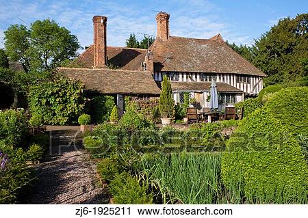 View of the garden, kitchen garden, box topiary, gravel path, house and relaxing area, Bexon Manor Kent England. View Large Photo Image Stock Image - View of the garden, kitchen garden, box topiary, gravel path, house and relaxing area, Bexon Manor Kent England.. Fotosearch