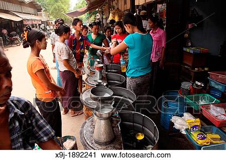 Stock Image - View of the Myinkaba market, cooking oil seller, Old Bagan, Pagan, Burma, Myanmar, Asia. Fotosearch