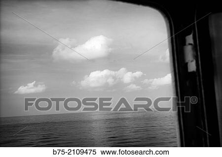 View of the sea and the sky through a window of a boat. Croosing the Mediterranean Sea from Ciutadella, Menorca to Alcudia, Mallorca, Balearic Islands, Spain View Large Photo Image Stock Photography - View of the sea and the sky through a window of a boat. Croosing the Mediterranean Sea from Ciutadella, Menorca to Alcudia, Mallorca, Balearic Islands, Spain. Fotosearch