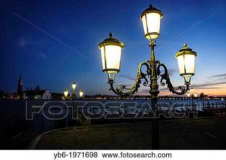 View of the Venice's waterfront with lighten up traditional street lamps, Venice, Italy. View Large Photo Image Stock Photo - View of the Venice's waterfront with lighten up traditional street lamps, Venice, Italy.. Fotosearch