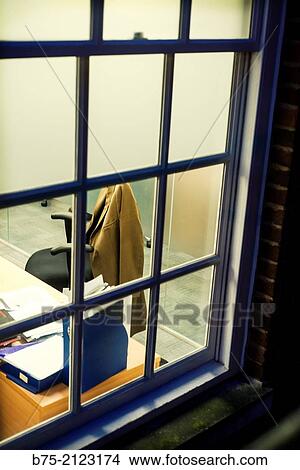 view through a window of an office chair with a jacket in London, England, UK, Europe. View Large Photo Image Picture - view through a window of an office chair with a jacket in London, England, UK, Europe.. Fotosearch
