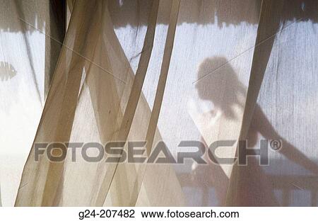 View through viel of curtains. Woman enjoying sunlinght on deck View Large Photo Image Stock Image - View through viel of curtains. Woman enjoying sunlinght on deck. Fotosearch