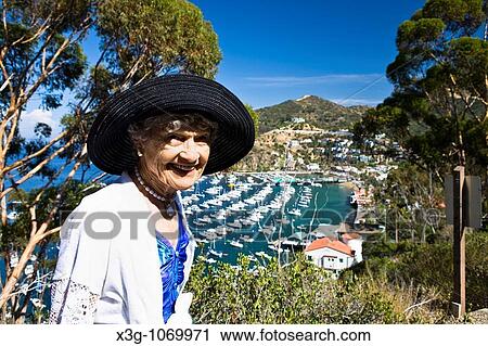 Views overlooking Avalon harbor from the north side. The Wrigley Mansion is on the other side of the hill and the Casino is in the foreground. View Large Photo Image Stock Image - Views overlooking Avalon harbor from the north side. The Wrigley Mansion is on the other side of the hill and the Casino is in the foreground.. Fotosearch