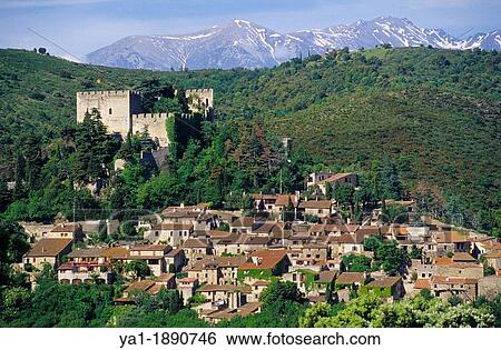 Stock Photograph - Village of Castelnou and back Canigou peak, Eastern Pyrenees, Languedoc-Roussillon, France. Fotosearch