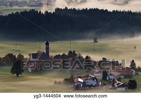 Village of Speiden in the Allgaeu and clearing autumn mist, Bavaria, Germany View Large Photo Image Picture - Village of Speiden in the Allgaeu and clearing autumn mist, Bavaria, Germany. Fotosearch