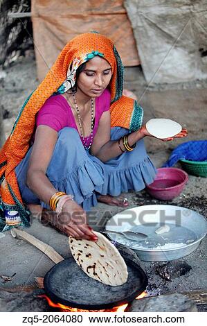 Village woman making bhakaris or Indian bread, Jhabua, Madhya Pradesh, India. View Large Photo Image Stock Image - Village woman making bhakaris or Indian bread, Jhabua, Madhya Pradesh, India.. Fotosearch