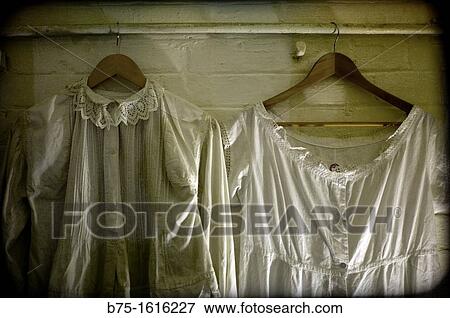 Vintage clothing on hangers in an antique shop View Large Photo Image Stock Photo - Vintage clothing on hangers in an antique shop. Fotosearch