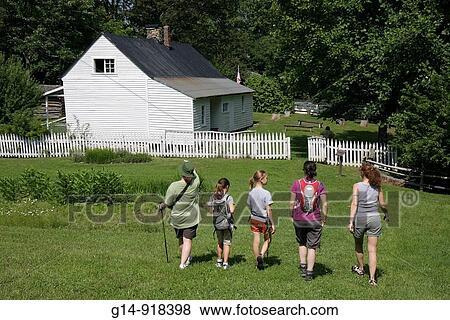 Stock Photo - Virginia, Appalachian Mountains, Blue Ridge Parkway, All-American Road, National Scenic Byway, Peaks of Otter, Johnson Farm, farmstead, 19th Century, house, white picket fence, woman, girl, hiking, living history, pioneer,. Fotosearch