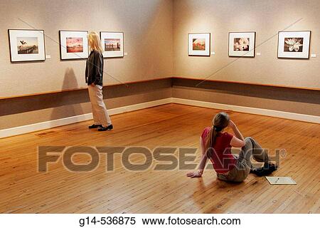 Stock Photography - Virginia, Chesapeake, Portlock Galleries at SoNo, framed photos, woman sitting, looking,. Fotosearch