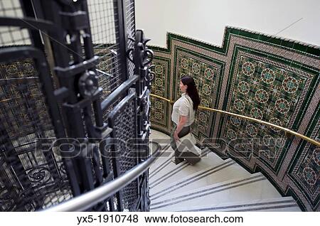 Stock Photo - Visitor descending the stairs in Madrid City Hall Cibeles Palace. Fotosearch
