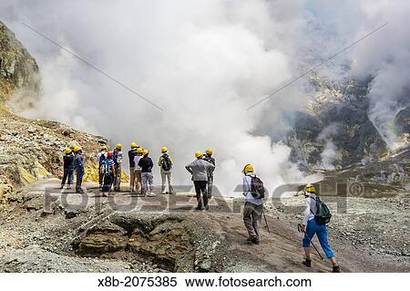 Stock Photography - Visitors at an active andesite stratovolcano on White Island, North Island, New Zealand.. Fotosearch