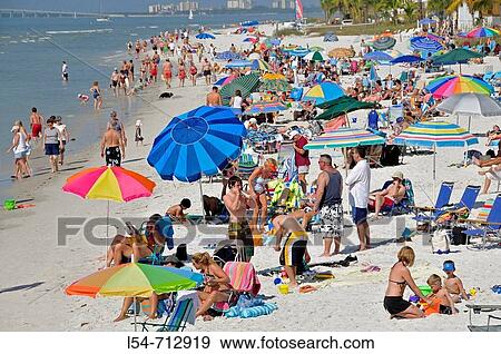 Stock Photo - Visitors to Fort Myers Beach Florida enjoy sun and water. Fotosearch