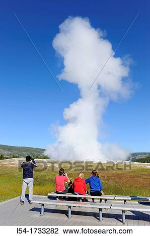 Visitors View Old Faithful Geyser Yellowstone National Park Wyoming, WY View Large Photo Image Stock Image - Visitors View Old Faithful Geyser Yellowstone National Park Wyoming, WY. Fotosearch