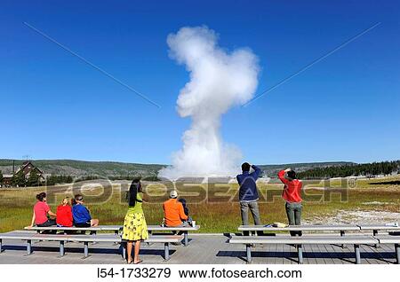 Stock Photo - Visitors View Old Faithful Geyser Yellowstone National Park Wyoming, WY. Fotosearch