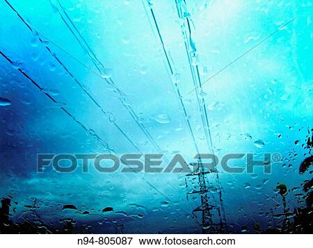 Stock Photo - Vista de un poste de suministro de electricidad a trav's del parabrisas de un coche, en un gris y lluvioso d? a.. Fotosearch