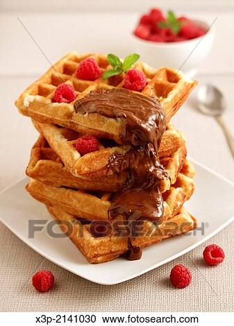 Stock Image - Waffles with chocolate and raspberries.. Fotosearch