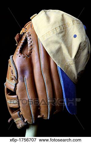 Stock Photo - Wait till next year A baseball glove and cap sitting on a wooden bat. Fotosearch