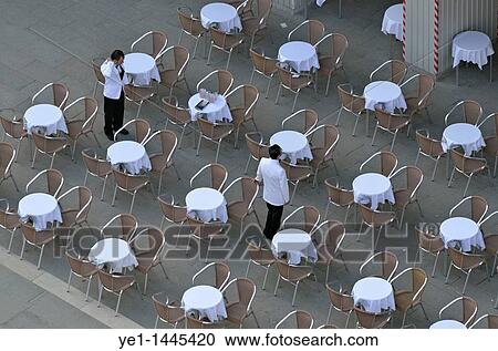 Waiters at empty cafe terrace on Piazza San Marco, elevated view from the Bell Tower, Venice, Italy View Large Photo Image Stock Image - Waiters at empty cafe terrace on Piazza San Marco, elevated view from the Bell Tower, Venice, Italy. Fotosearch
