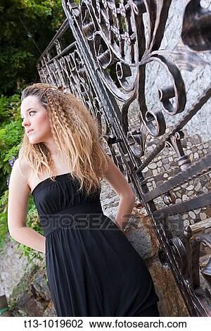 Waiting next to a closed entrance door young woman View Large Photo Image Stock Image - Waiting next to a closed entrance door young woman. Fotosearch