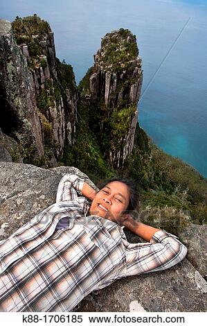 Stock Photography - Walker on top of Bishop and Clerk 620 m Maria Island, Tasmania, Australia. Fotosearch