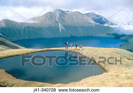 Walking group above Green Lake. Fiordland National Park. New Zealand. View Large Photo Image Stock Photo - Walking group above Green Lake. Fiordland National Park. New Zealand.. Fotosearch