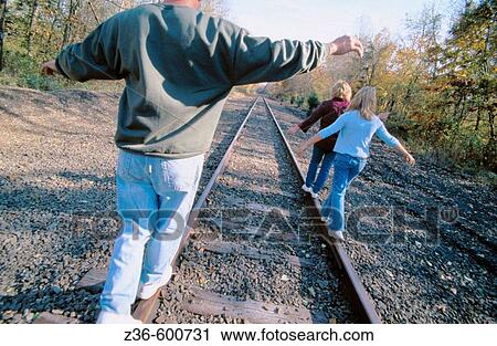 Stock Image - Walking on a railroad. Fotosearch