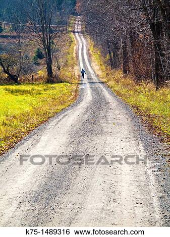 Stock Photograph - Walking on country road. Fotosearch