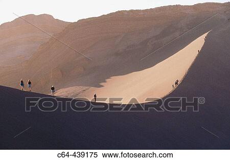 Walking on dunes. Valle de la Luna (Valley of the Moon ). Atacama desert. Chile View Large Photo Image Stock Photography - Walking on dunes. Valle de la Luna (Valley of the Moon ). Atacama desert. Chile. Fotosearch