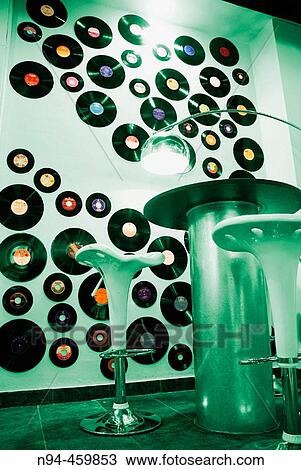 Wall decorated with old vinyl records of various sizes and furniture in the style of the 60. View Large Photo Image Stock Image - Wall decorated with old vinyl records of various sizes and furniture in the style of the 60.. Fotosearch